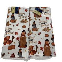 two thanksgiving napkins with gnomes and pumpkins on them, one is white