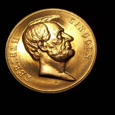 an old gold coin with a man's face on it