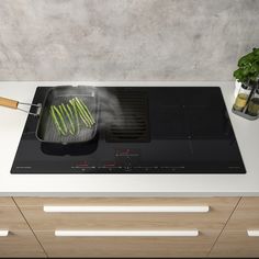 a stove top that has some food cooking on it with a spatula over the burner