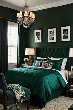 a bedroom decorated in green and white with a chandelier hanging from the ceiling