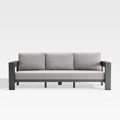 a gray couch sitting on top of a white floor