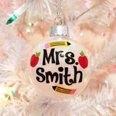 a christmas ornament with the words mrs smith on it hanging from a tree