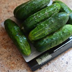 cucumbers are sitting on top of a scale