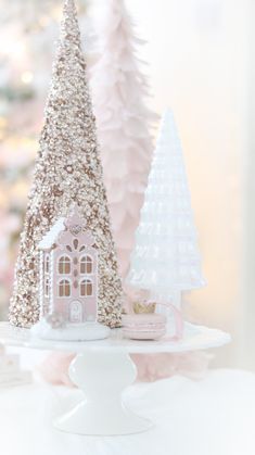 two small christmas trees on a cake stand