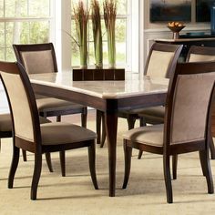 a dining room table with chairs around it