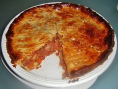 a cheese pie on a white plate with one slice missing