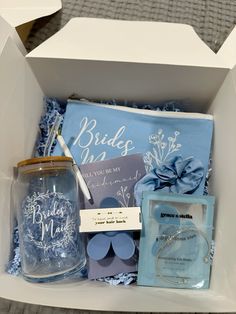 a blue gift box filled with personalized items and a note that says, bride in law