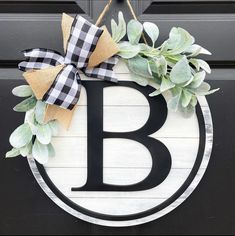 a black and white wreath with the letter b on it