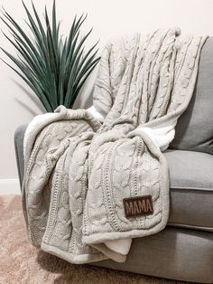 a couch with a blanket on it and a potted plant