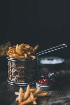 french fries in a basket with ketchup on the side