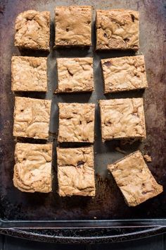 brownies are cut into squares on a baking sheet, ready to be baked in the oven