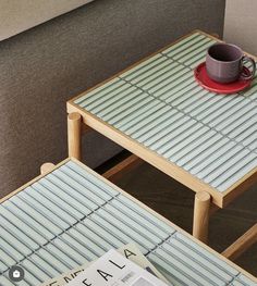 two tables with coffee cups and magazines on them