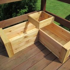 two wooden boxes sitting on top of a wooden deck