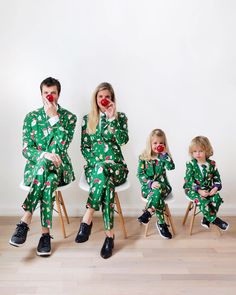 three people in matching christmas pajamas sitting on chairs with noses painted to look like clowns