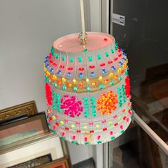 a colorful light hanging from a ceiling in a room