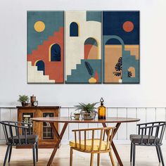 two paintings hanging on the wall above a dining room table with chairs and a cabinet