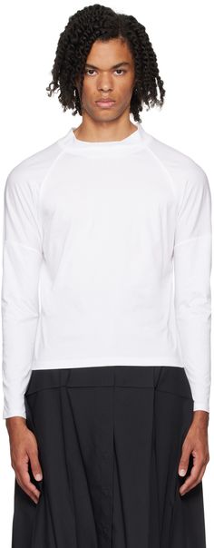 Cotton jersey long sleeve T-shirt. Pinched seams throughout. · Rib knit mock neck · Raglan sleeves Supplier color: White White Funnel Neck Tops With Ribbed Cuffs, White Long Sleeve Turtleneck With Ribbed Cuffs, White High Neck Tops With Ribbed Cuffs, White Long Sleeve Mock Neck Top For Layering, Casual Mock Neck Long Sleeve Top With Thumbholes, Sporty White Turtleneck Top, Sporty Cotton Turtleneck Top, White Mock Neck, Jersey Long Sleeve