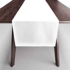 a long table with a white cloth on it and a black knife sticking out of the top