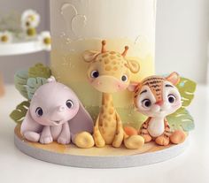 a close up of a cake with animals on it