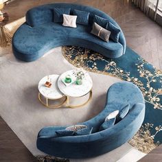 a living room filled with blue couches and tables on top of a carpeted floor