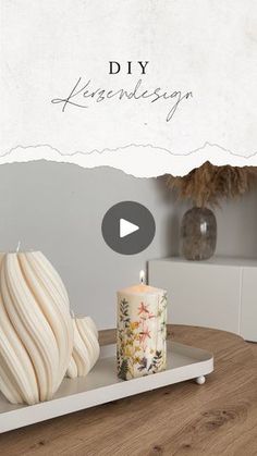 a white candle sitting on top of a wooden table