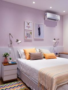 a bedroom with purple walls and white bedding