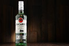 a bottle of bacardi on a wooden table