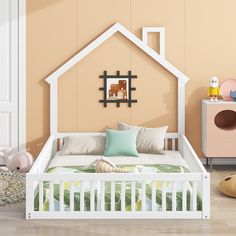 a child's room with a bed, dresser and toy house on the wall