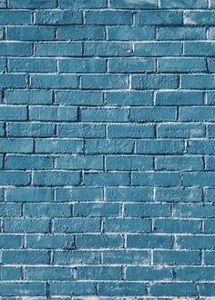 a blue brick wall with white lines painted on it