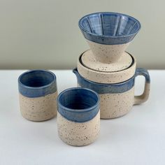 three blue and white cups sitting next to each other on top of a countertop