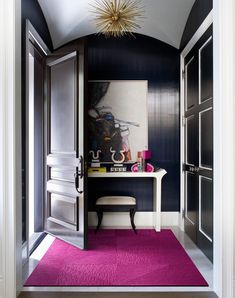 the hallway is decorated in black and white, with purple carpeting on the floor