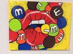 a painting on a white wall with many different colored balls and letters in the shape of a woman's mouth