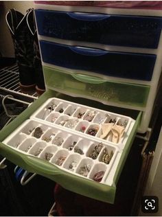 a green and white drawer filled with lots of jewelry