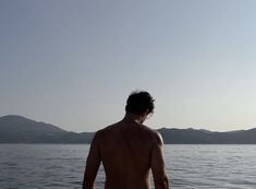 a man standing on top of a boat in the water