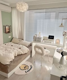 a bed room with a neatly made bed next to a desk and chair in front of a window