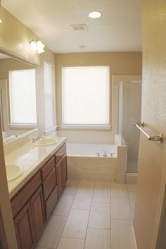 a bathroom with two sinks and a bathtub