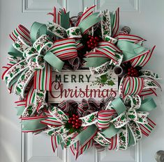 Get ready to spread holiday cheer with this beautifully crafted Merry Christmas wreath! Measuring approximately 30 inches in diameter and 6 inches in depth, this statement piece is sure to capture the spirit of Christmas. This festive wreath features a mix of striped, holly-printed, and satin ribbons, topped with red berry accents and a rustic "Merry Christmas" sign at the center. Each ribbon is carefully arranged to create a full and luxurious look, perfect for enhancing your holiday decor. This wreath is ideal for doors, walls, or above the fireplace, bringing a pop of color and festive charm to any space. Made with high-quality, durable materials, it will be a treasured part of your holiday decorations for years to come. Product Details: Diameter: Approximately 30"  Depth: 6 inches from Traditional Wreath Christmas, Holiday Door Decorations, Holly Print, Christmas Entryway, Merry Christmas Wreath, Traditional Wreath, Winter Wreaths, Grapevine Wreaths