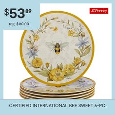 a set of four plates with yellow flowers and a bee on them for $ 53 99