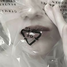 a woman's face is covered in plastic with the word do not enter on it