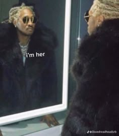 a man with dreadlocks looking at his reflection in a mirror that says, i'm her