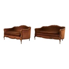 two brown leather couches sitting next to each other on top of a white background