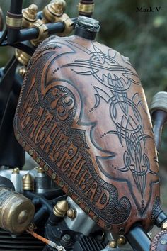 the back end of a motorcycle with an intricate leather cover