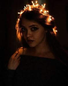 a woman wearing a crown of lights in her hair