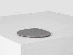 a round object sitting on top of a white surface