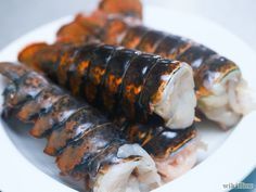 some food is on a white plate and ready to be eaten with chopsticks