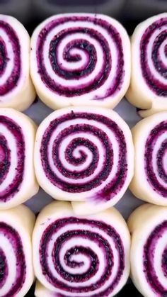 several purple and white rolls sitting on top of each other