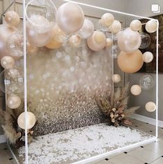 a room with balloons, feathers and other decorations on the floor in front of it