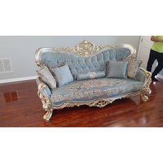 a blue couch sitting on top of a hard wood floor