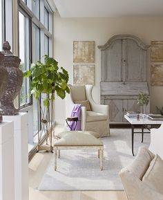 a living room filled with furniture and lots of window sill next to a wall