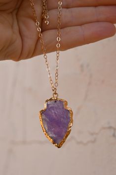 When you wear this Amethyst Arrowhead necklace, you'll instantly feel grounded! Place your hand over it throughout the day and channel the power that Amethyst holds. Amethyst is the stone of your highest self. It opens the doorway to the divine asking you to trust in the magic of your dreams. Amethyst gemstone arrowhead pendant with gold detailing 14k gold fill cable chain 3x4mm Handmade in Arizona Please use the size guide below to confirm your length. Contact us if you would like a length that Purple Gemstone Amulet Necklace, Purple Necklace With Large Stone For Gift, Purple Amethyst Amulet Necklaces, Purple Amethyst Amulet Necklace, Spiritual Purple Necklace With Large Stone, Purple Jewelry With Large Stone For Healing, Purple Amethyst Necklace With Raw Stone, Spiritual Arrowhead Necklace Gift, Amethyst Raw Stone Necklace For Healing